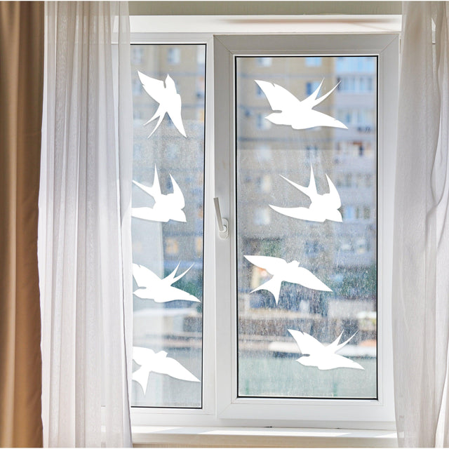 Anti-collision bird stickers applied to a window to prevent bird collisions and enhance home decor.
