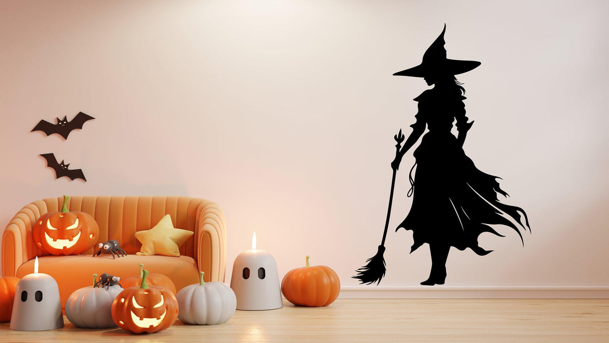 Wicked Witch Silhouette Window Decal on a wall with Halloween decorations and pumpkins.
