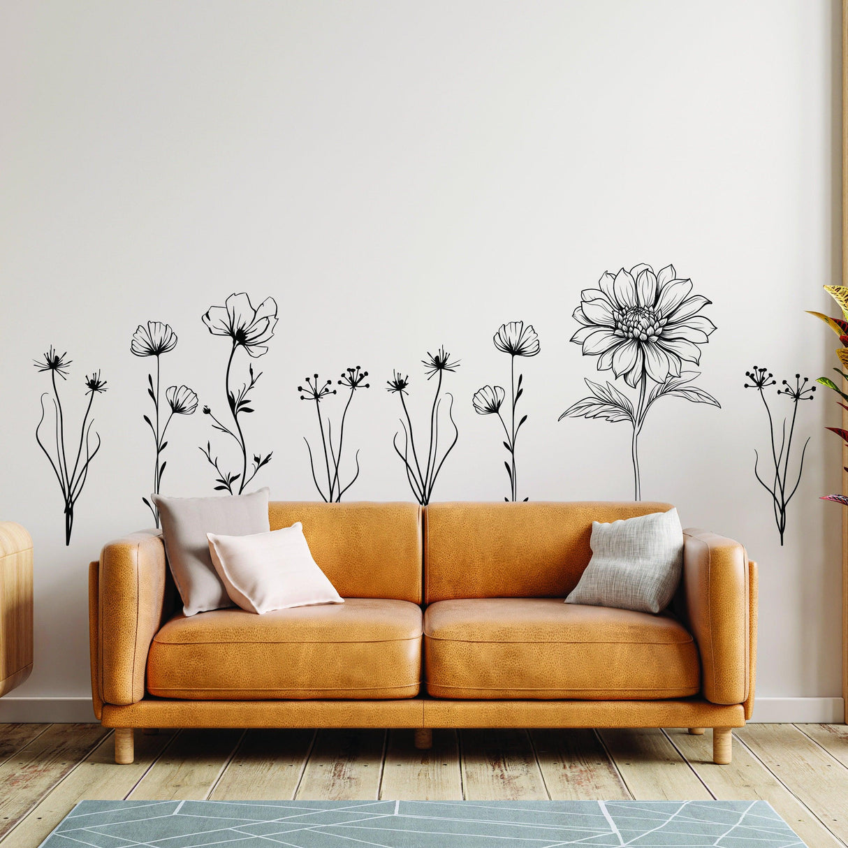 Elegant hand-sketched British wildflower wall stickers above a stylish sofa in a modern living space.