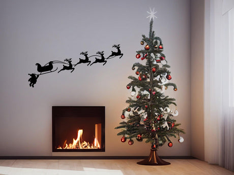 Humorous Santa sleigh and reindeer wall decal above a Christmas tree with a fireplace, adding festive charm.