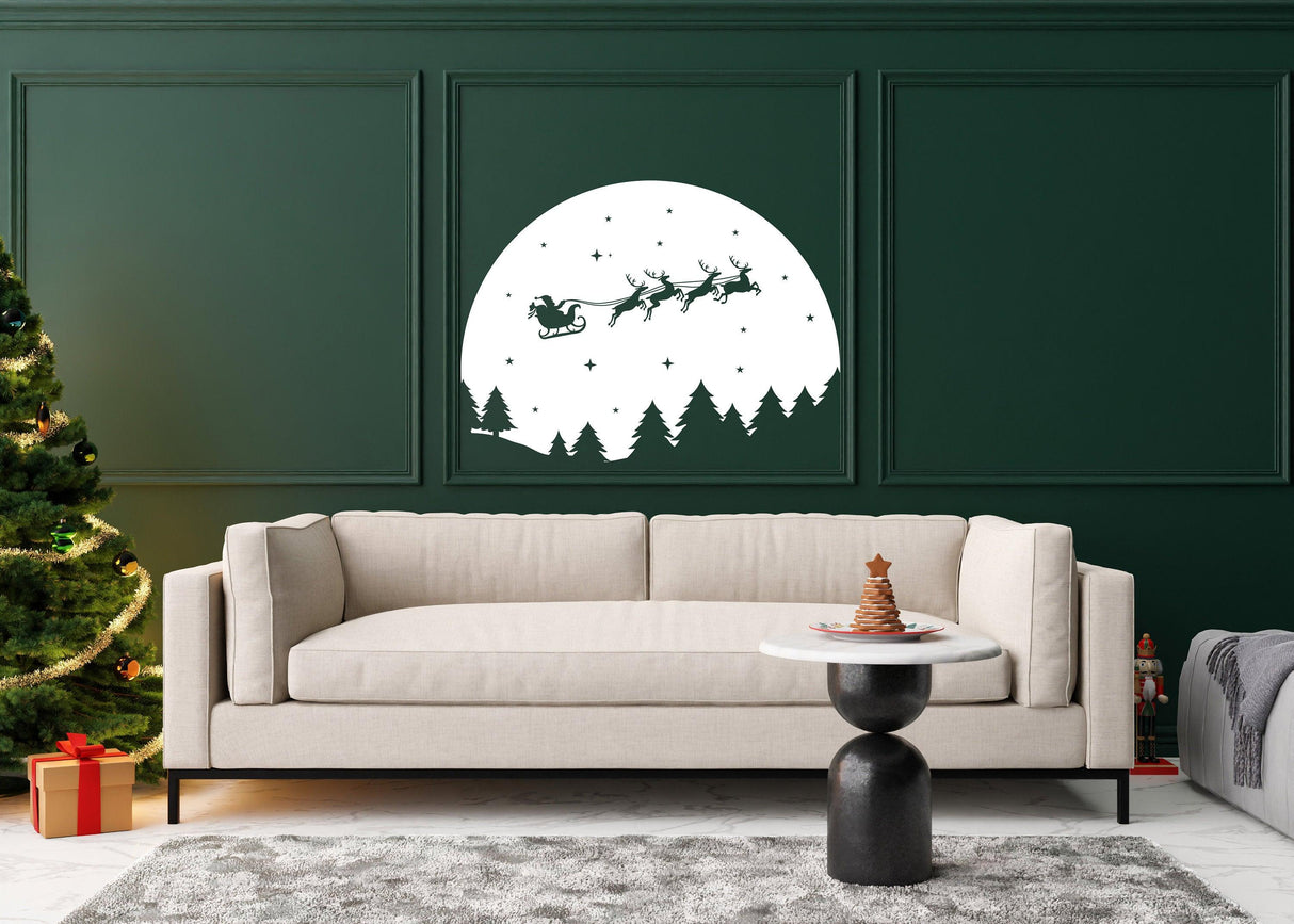 Starry Sky Santa and sleigh wall decal above a cozy sofa in a festive living room with Christmas tree.