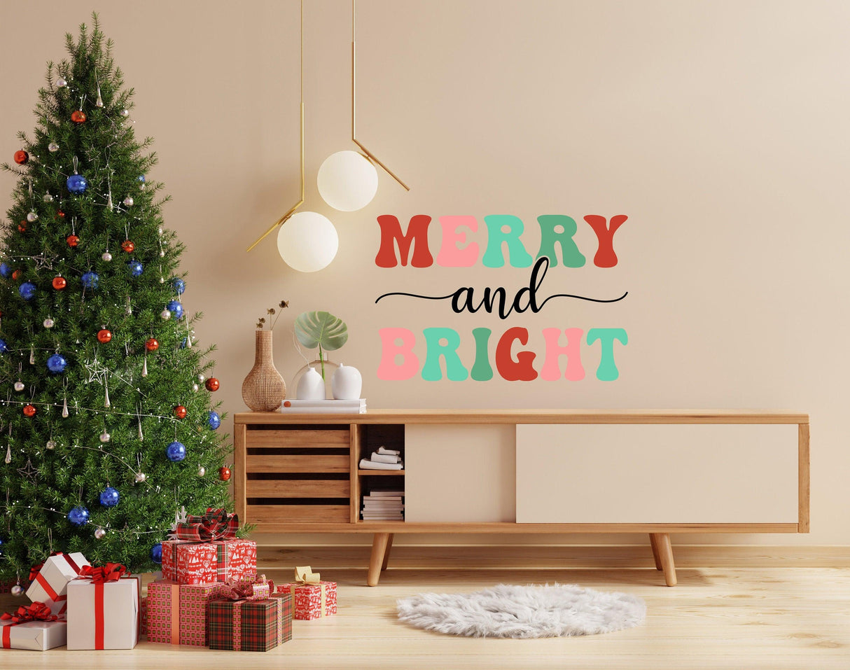 Merry and Bright Christmas wall decal above a decorated tree and gifts in a cozy living room setting.