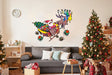 Colorful Santa in glasses in sleigh with reindeer wall decal over festive living room decor for Christmas.
