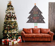 Whimsical Christmas tree with legs wall sticker saying 'Keep Calm and Merry On' above a cozy sofa with a decorated Christmas tree.
