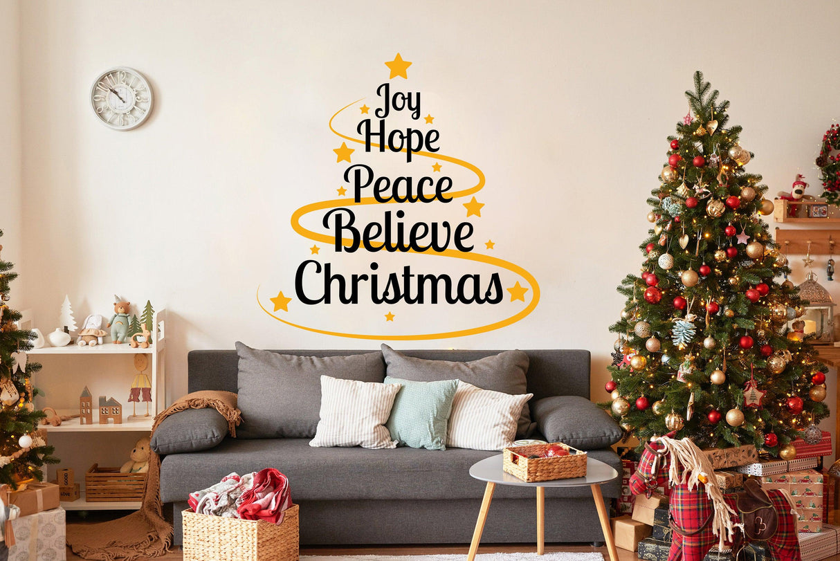 Colorful Christmas quote wall vinyl sticker with 'Joy Hope Peace Believe Christmas' in a cozy living room.