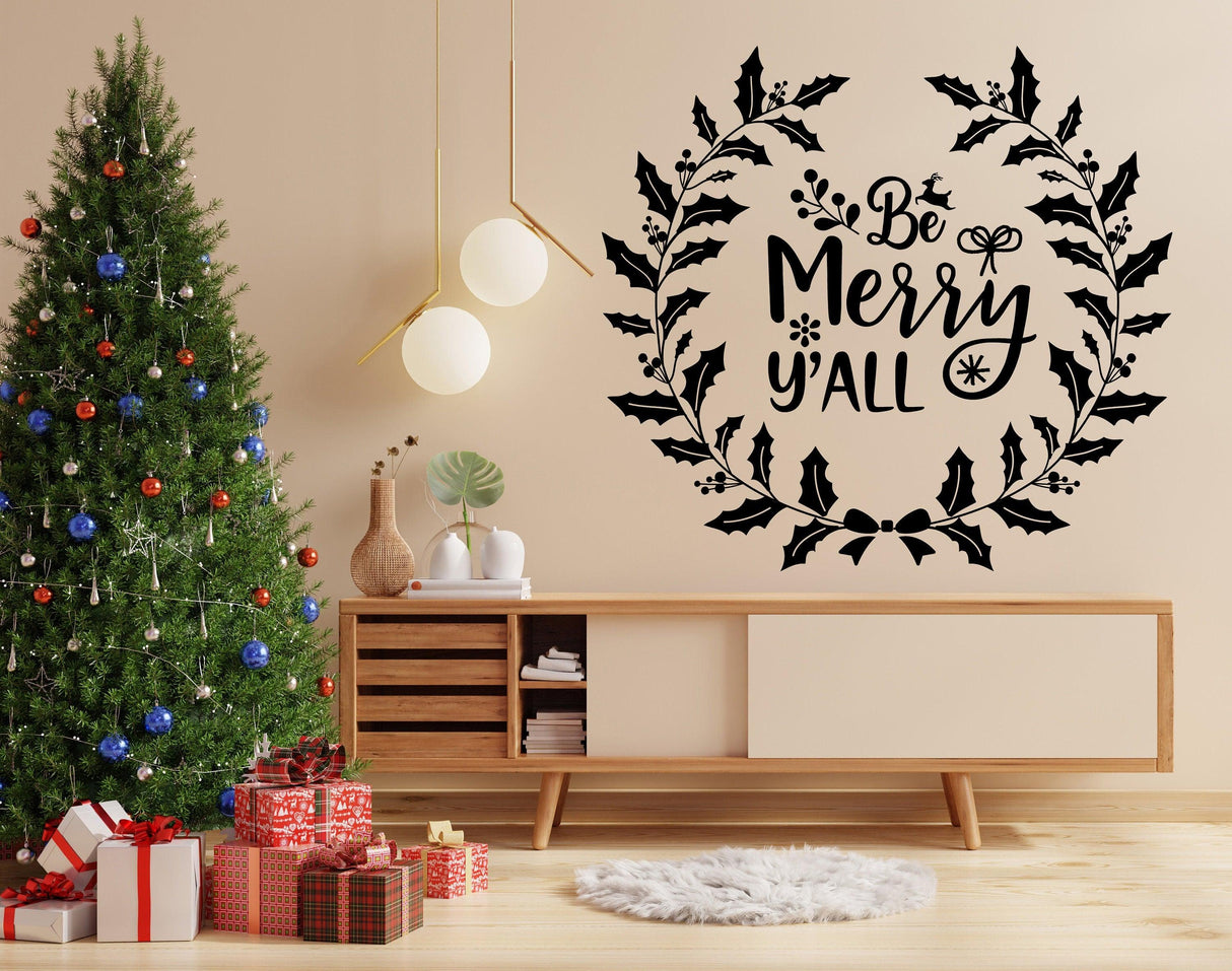 Charming Christmas wall sticker 'Be Merry y'all' displayed above a festive tree and decor, adding holiday cheer.