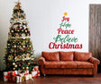 Joy Hope Peace Believe Christmas wall decal above a cozy sofa and decorated tree, enhancing festive living room decor.