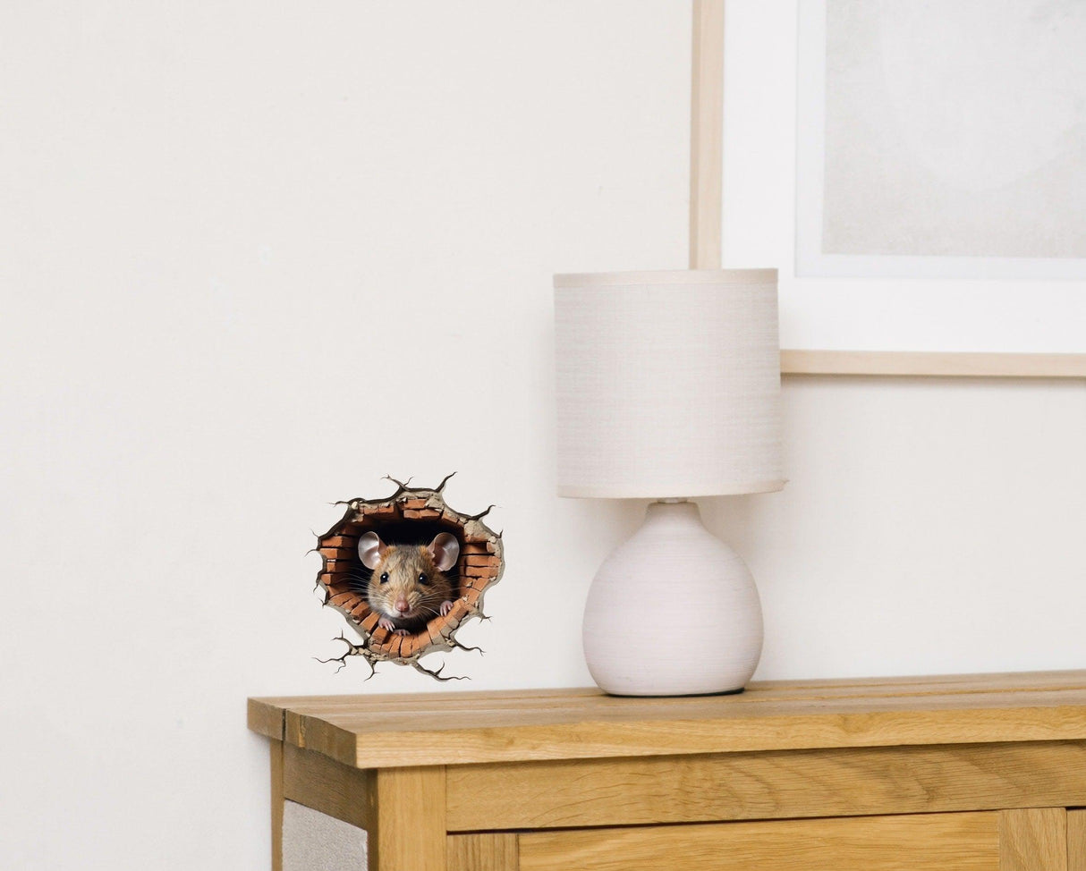 Realistic 3D mouse hole wall sticker with a mouse peeking out, adding charm to home decor next to a lamp.