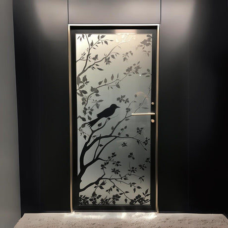 Elegant frosted black tree silhouette decal on glass door with a bird design, adding privacy and aesthetic appeal.