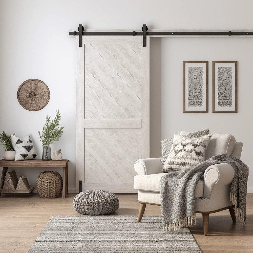 Cozy living room featuring a white barn door, stylish armchair, and decorative elements for rustic charm.