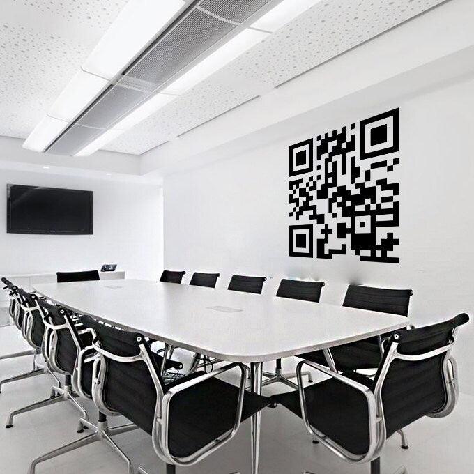 A modern conference room featuring a large custom QR code sticker on the wall above a long white table.