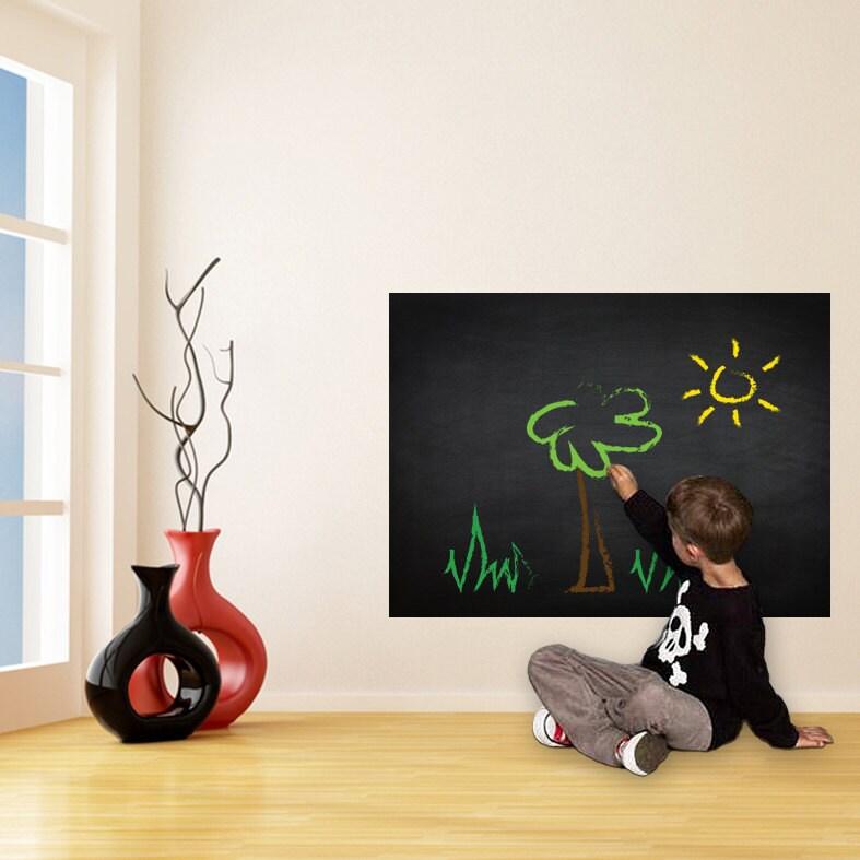 Child drawing a tree and sun on a Chalkboard Wall DIY vinyl sticker in a modern kitchen.