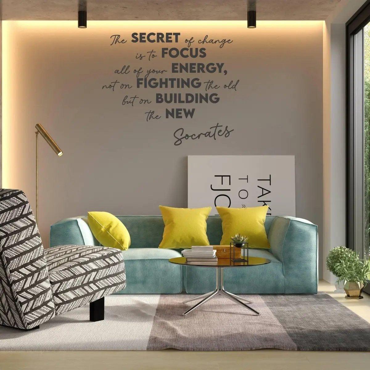 Living room with motivational vinyl decal: 'The secret of change is to focus on building the new' by Socrates.