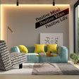 Motivational vinyl decal saying 'Positive Mind, Positive Vibes, Positive Life' on a stylish living room wall.
