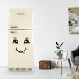 Cute smiley face decal on retro beige fridge in a stylish kitchen setting, adding happiness to home decor.