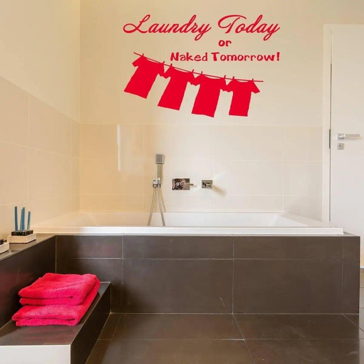 Laundry room vinyl sticker saying 'Laundry Today or Naked Tomorrow' above a stylish bathtub with towels.