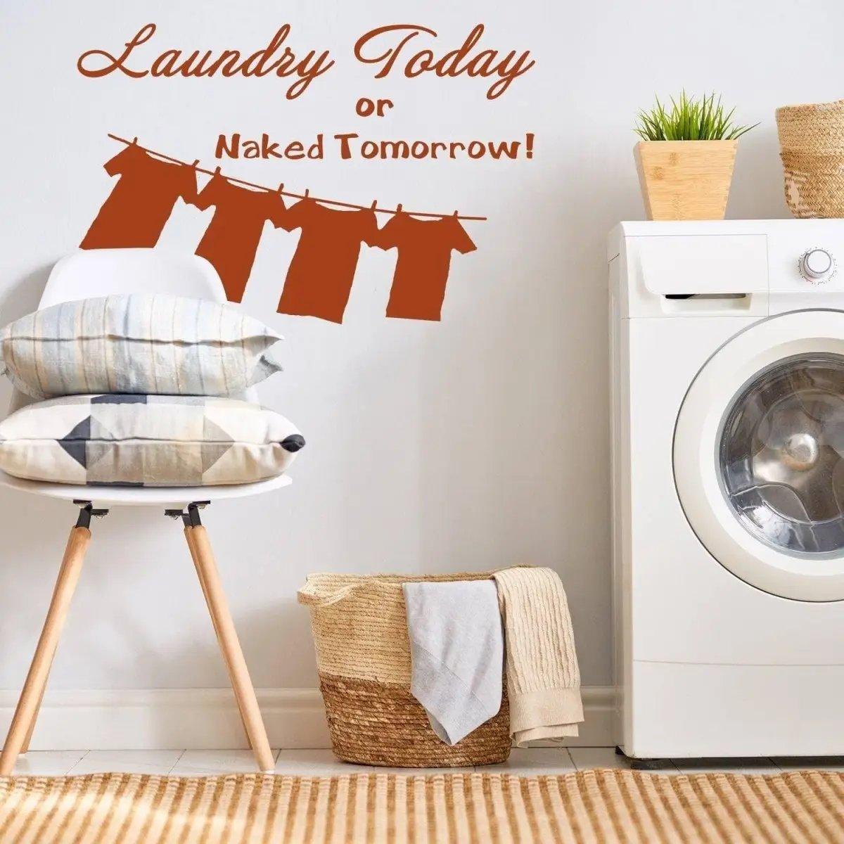 Laundry Today or Naked Tomorrow vinyl sticker in a stylish laundry room with stacked pillows and a washing machine.