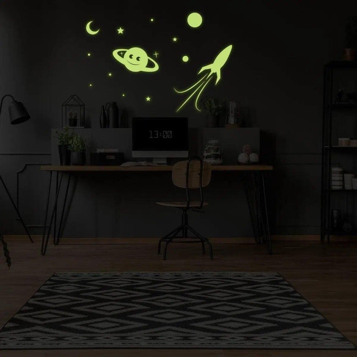 Glow in the dark star wall stickers with planets and rocket in a cozy home office setting.