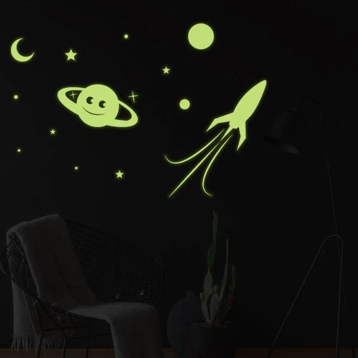 Glow in the dark star wall stickers with planets and rocket, perfect for cosmic themed room decor.