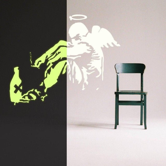 Glowing Guardian Angel wall sticker showcasing a luminescent angel figure beside a green chair in a modern room.