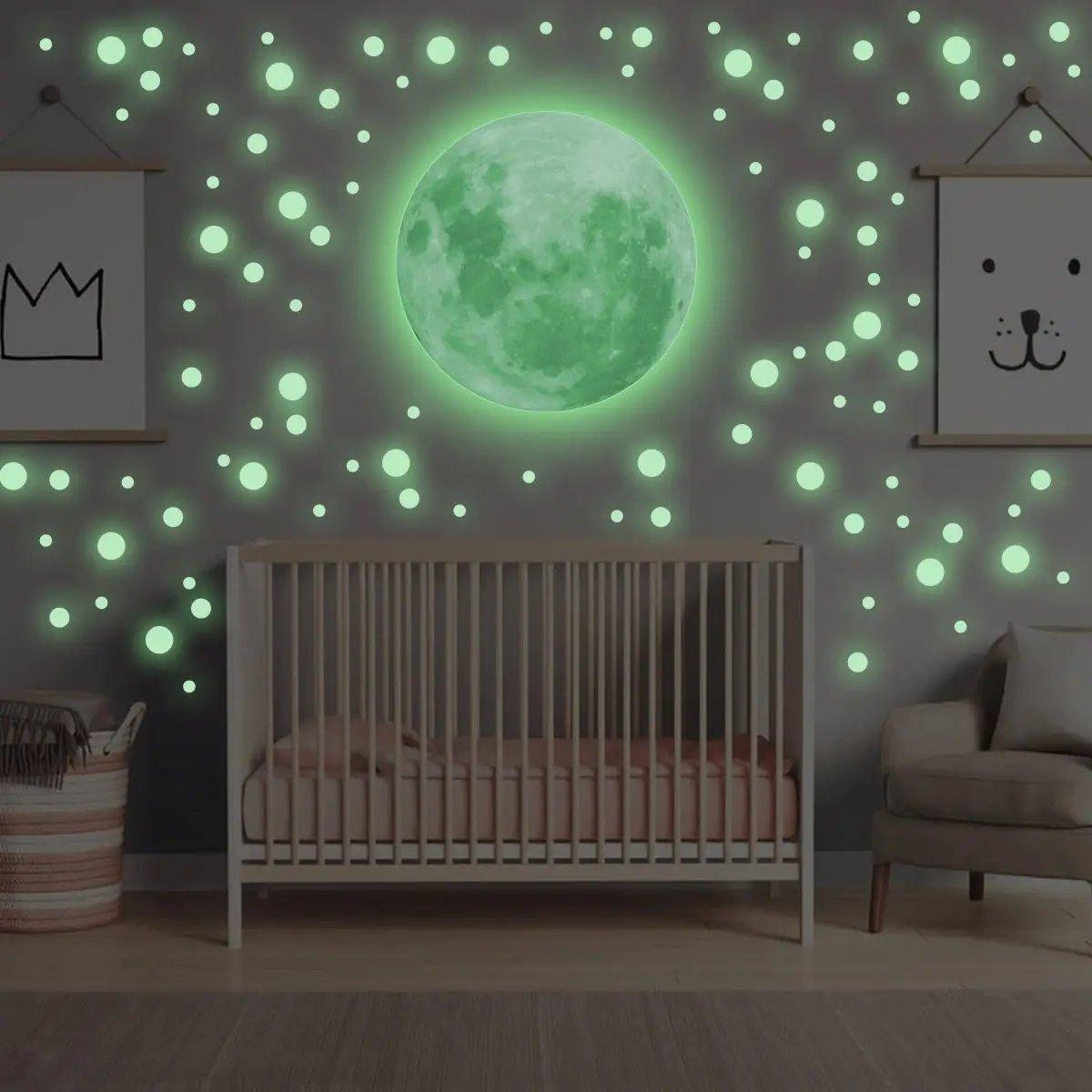 Luminous moon and glowing star wall decals in a nursery, creating a magical sleeping environment for children.