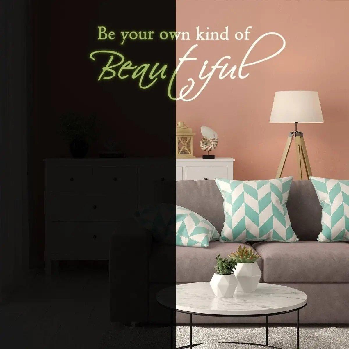 Glowing wall sticker with the quote 'Be your own kind of Beautiful' in a stylish living room setting.