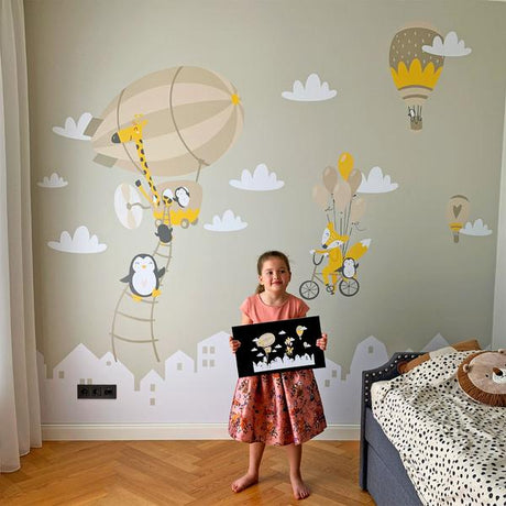 Finished children's bedroom wall with an airship, hot-air balloons, animals, clouds and house shapes