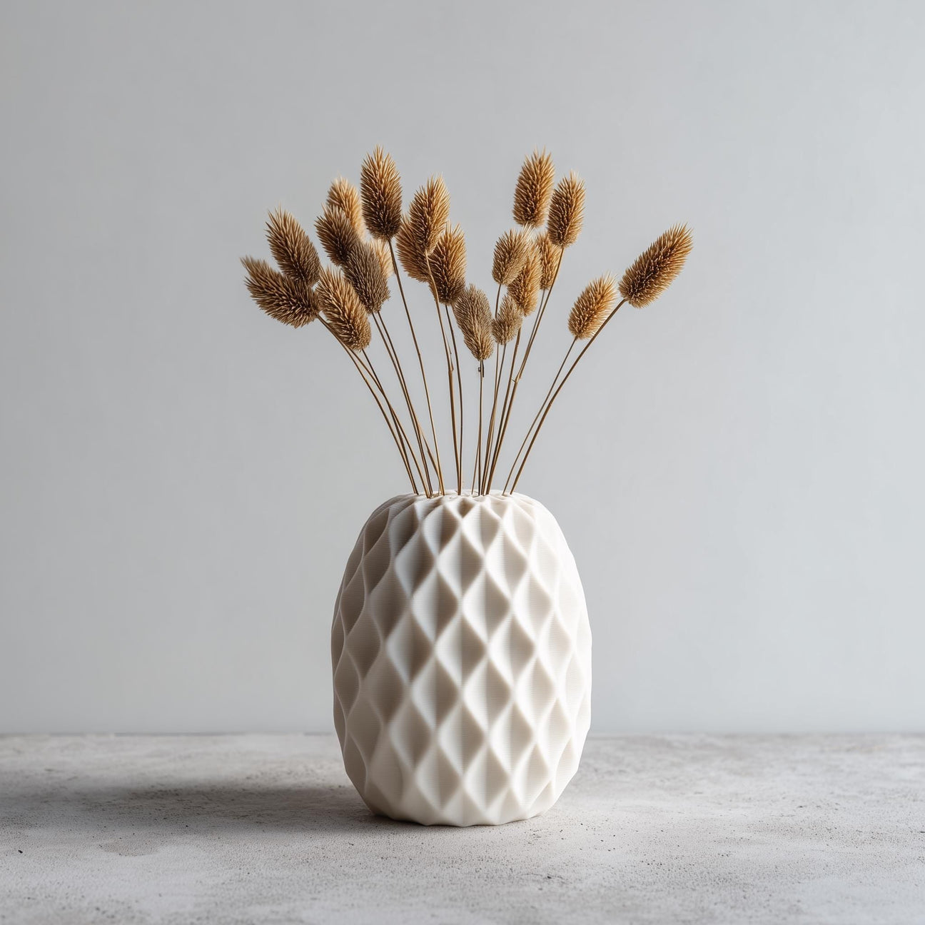 White 3D printed geometric vase with diamond texture and dried flowers
