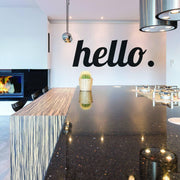 Stylish kitchen with a black 'hello.' wall decal and modern countertop design.