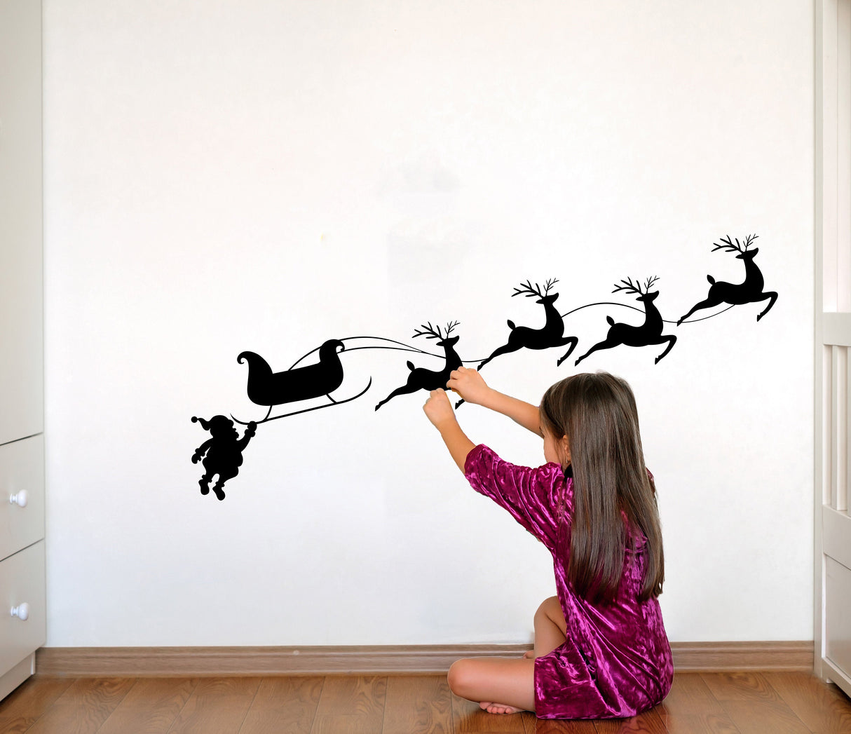 Santa sleigh and reindeer wall decal shown in an alternate seasonal interior view.
