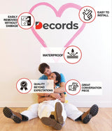 Couple sitting on the floor next to wall decal highlights including waterproof and easy installation features.