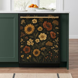 A dishwasher front panel in a modern green kitchen with a vintage-style floral design featuring sunflowers, marigolds, poppies, and leafy stems in warm autumn tones on a black background. The decal adds an elegant botanical charm to the kitchen.