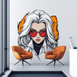 A bold anime-style wall decal of a confident woman with white hair, red sunglasses, and a serious expression, styled in comic book fashion with clean outlines and warm tones, placed above two modern orange chairs.