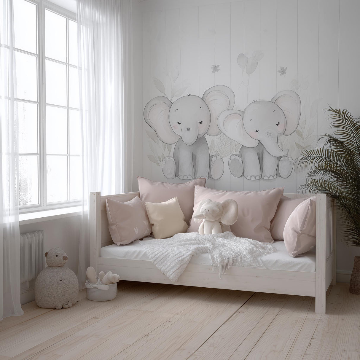A soft-toned nursery with two hand-drawn baby elephant decals on the wall above a daybed, styled with blush pink pillows, a plush elephant toy, and natural wood accents in a serene, light-filled space.