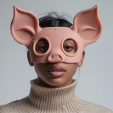 3D printed pig face mask with soft rounded design and large ears, worn by an adult model indoors, matte PLA plastic cosplay and costume accessory