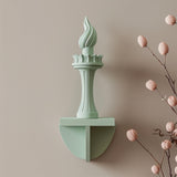 3D printed wall decor shaped like the Statue of Liberty torch, minimalist modern sculpture made of matte PLA plastic mounted on a neutral wall.