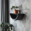 3D printed minimalist half-circle wall shelf with curved design and modern matte PLA finish, styled with a small plant