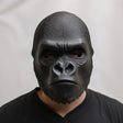 Front view of a 3D printed gorilla face mask worn by a person, showing realistic sculpted fur texture and matte black finish against a neutral background.