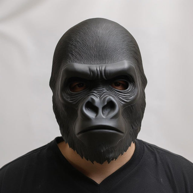 Front view of a 3D printed gorilla face mask worn by a person, showing realistic sculpted fur texture and matte black finish against a neutral background.