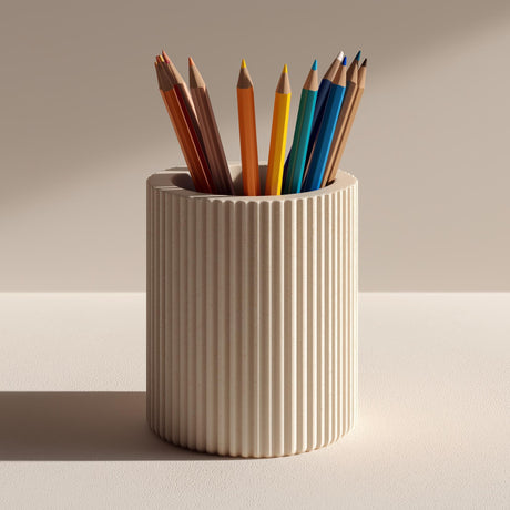 Cream-colored cylindrical 3D printed pencil holder with vertical ribbed grooves, shown with colorful pencils for illustration; pencils are not included.