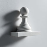 3D printed wall shelf with a large minimalist chess pawn integrated into a small rectangular ledge, made from matte PLA plastic on a light wall.