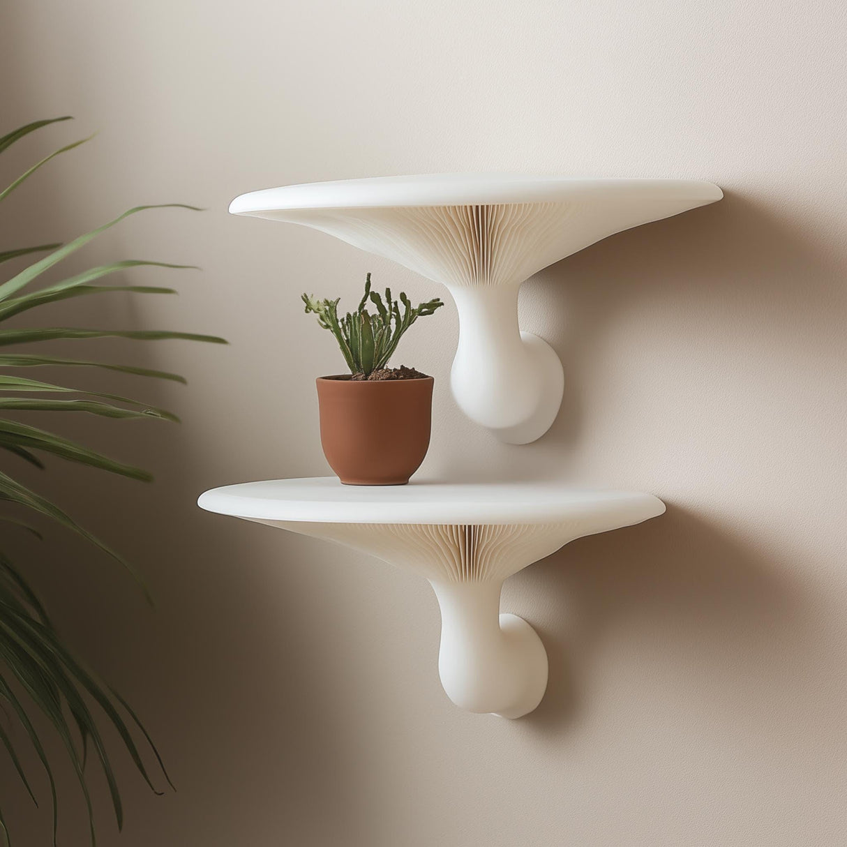 &quot;Pair of white 3D printed mushroom-inspired wall shelves mounted on a neutral wall, styled with a terracotta potted cactus.&quot;