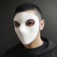 Man wearing a matte white 3D printed full-face cosplay mask with subtle contouring and wide eye cutouts, against a gray background.