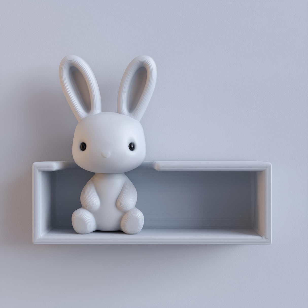 3D printed matte PLA wall shelf with an integrated sitting bunny figure and a recessed ledge space, mounted on a light-colored wall.
