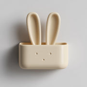 3D printed matte PLA wall-mounted bunny organizer box with tall rabbit ears and a small front pocket on a light wall.
