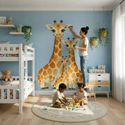 Watercolor giraffe family vinyl wall decal displayed in a nursery interior.