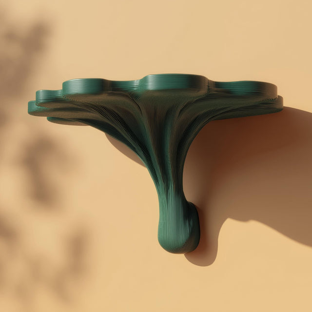 3D printed fantasy mushroom wall shelf with an organic stem base and wide cap-shaped floating ledge, mounted on a softly lit textured wall.