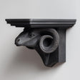 3D printed ram head wall shelf with curved horns supporting a flat floating ledge, mounted on a clean minimalist wall.