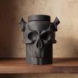 3D printed dark fantasy pet cremation urn shaped as a horned skull, gothic memorial decor displayed on a wooden shelf.