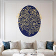An intricate illustration of three large golden orchids on a deep navy blue oval background. The flowers and surrounding vines are rendered with highly detailed filigree line-work and decorative dot patterns. The entire oval is centered on a white background.